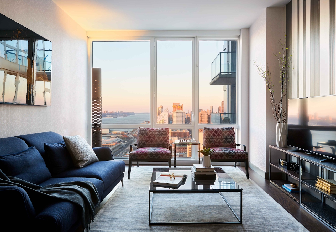 a view of a living room filled with furniture and a large window
