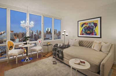 a living room filled with furniture and a large window