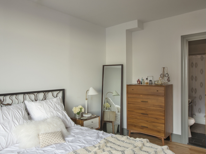 a bedroom with a bed in a room