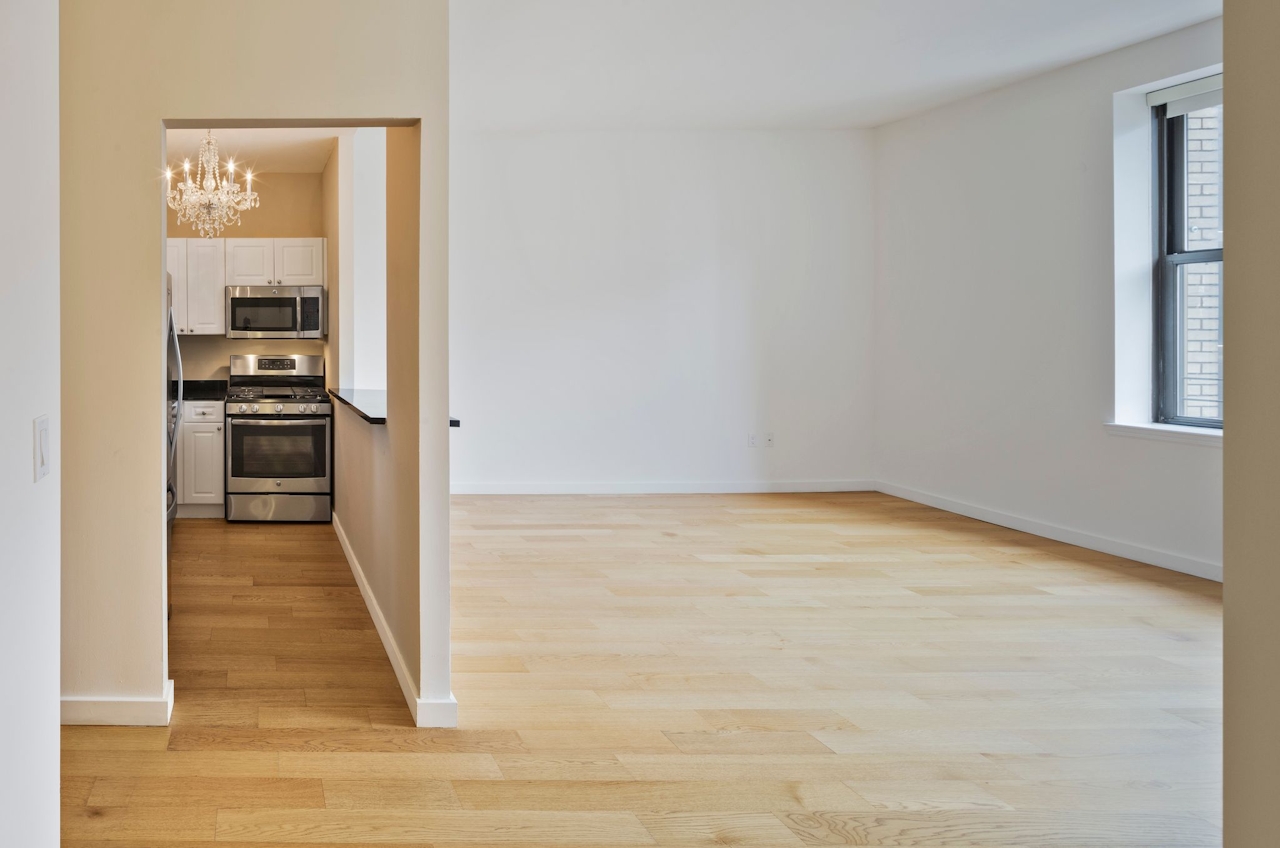 a large empty room with a wood floor