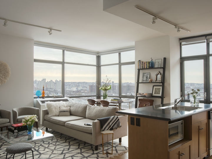 a living room filled with furniture and a large window
