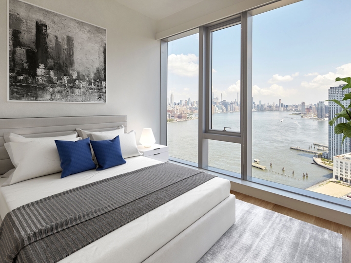 a hotel room with a bed and a large window