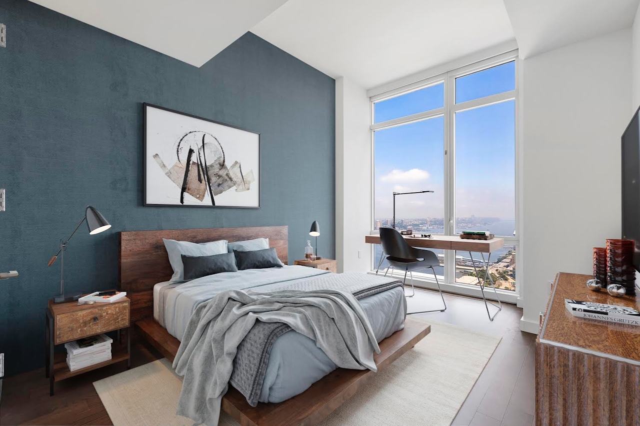 a bedroom with a bed and desk in a room