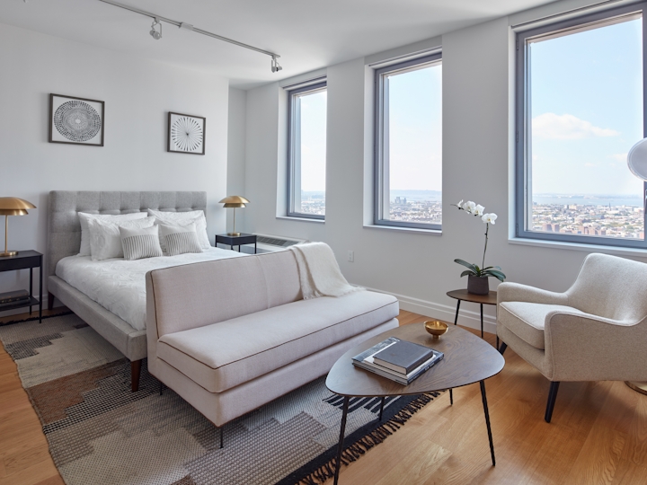 a living room filled with furniture and a large window