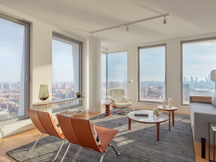a view of a living room filled with furniture and a large window