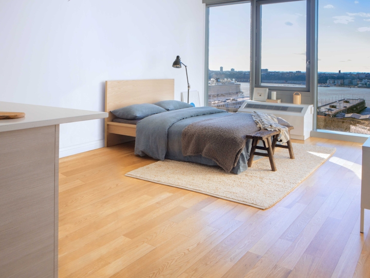 a living room filled with furniture and a large window