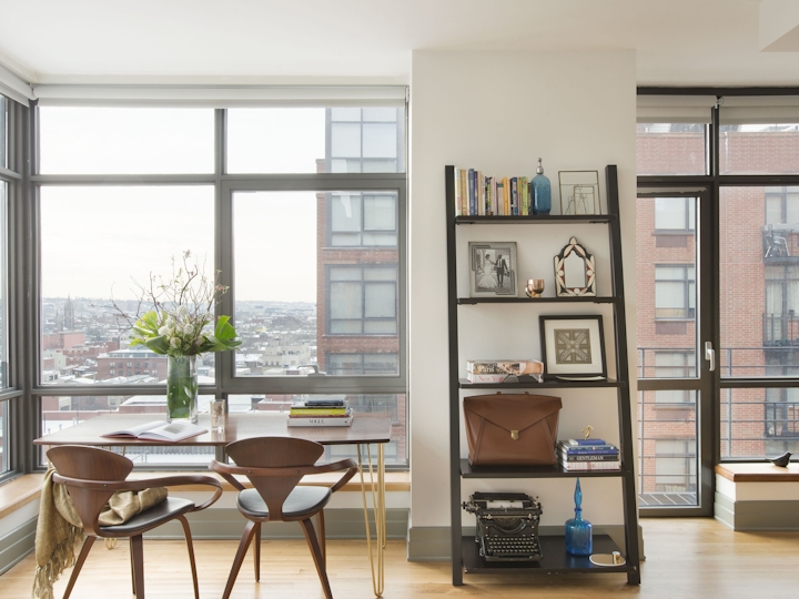 a living room filled with furniture and a large window