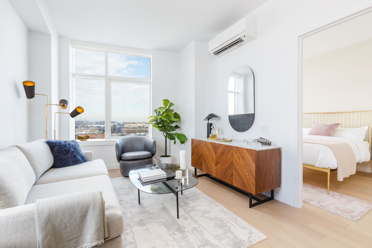 a living room filled with furniture and a large window