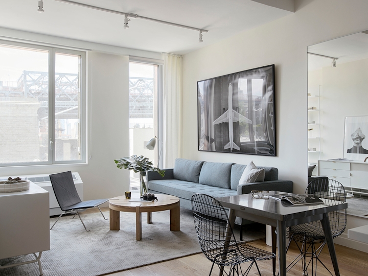 a living room filled with furniture and a large window