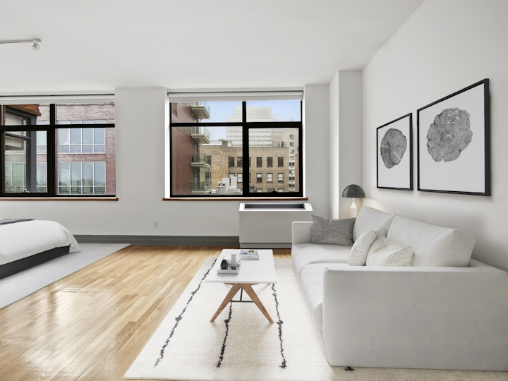 a living room filled with furniture and a large window