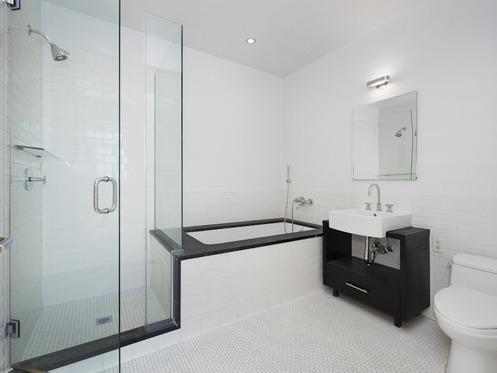 a white sink sitting next to a shower