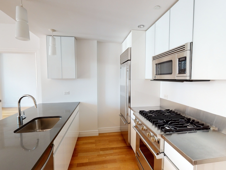 a stove top oven sitting inside of a kitchen