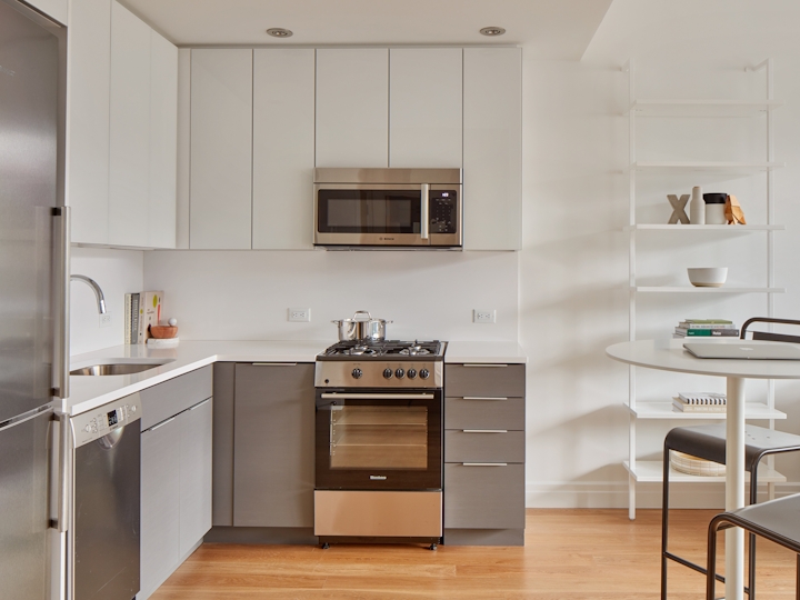 a kitchen with white appliances and wooden cabinets