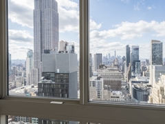 Thumbnail of Atlas New York: 33F a view of a city next to a window