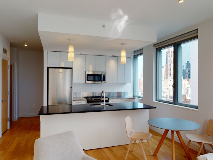 a living room filled with furniture and a large window