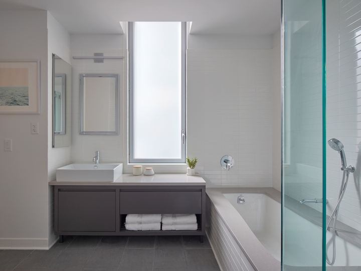 a large white tub next to a window