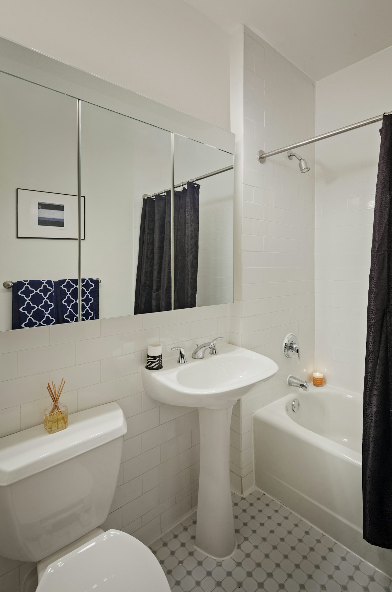 a white sink sitting under a mirror