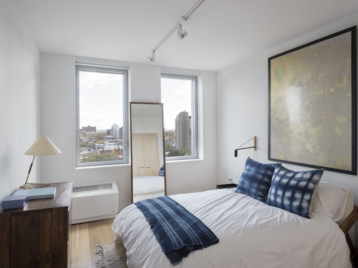 a bedroom with a bed and a window