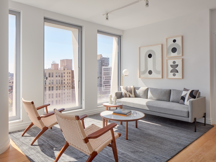 a living room filled with furniture and a large window