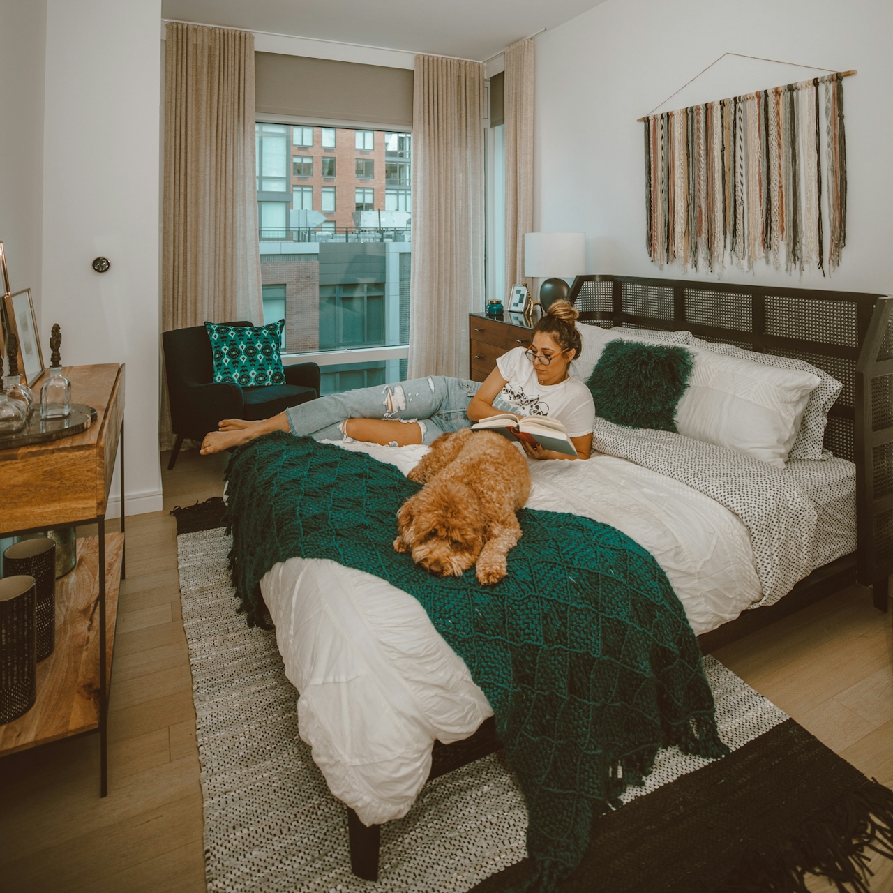 a large brown teddy bear sitting on top of a bed