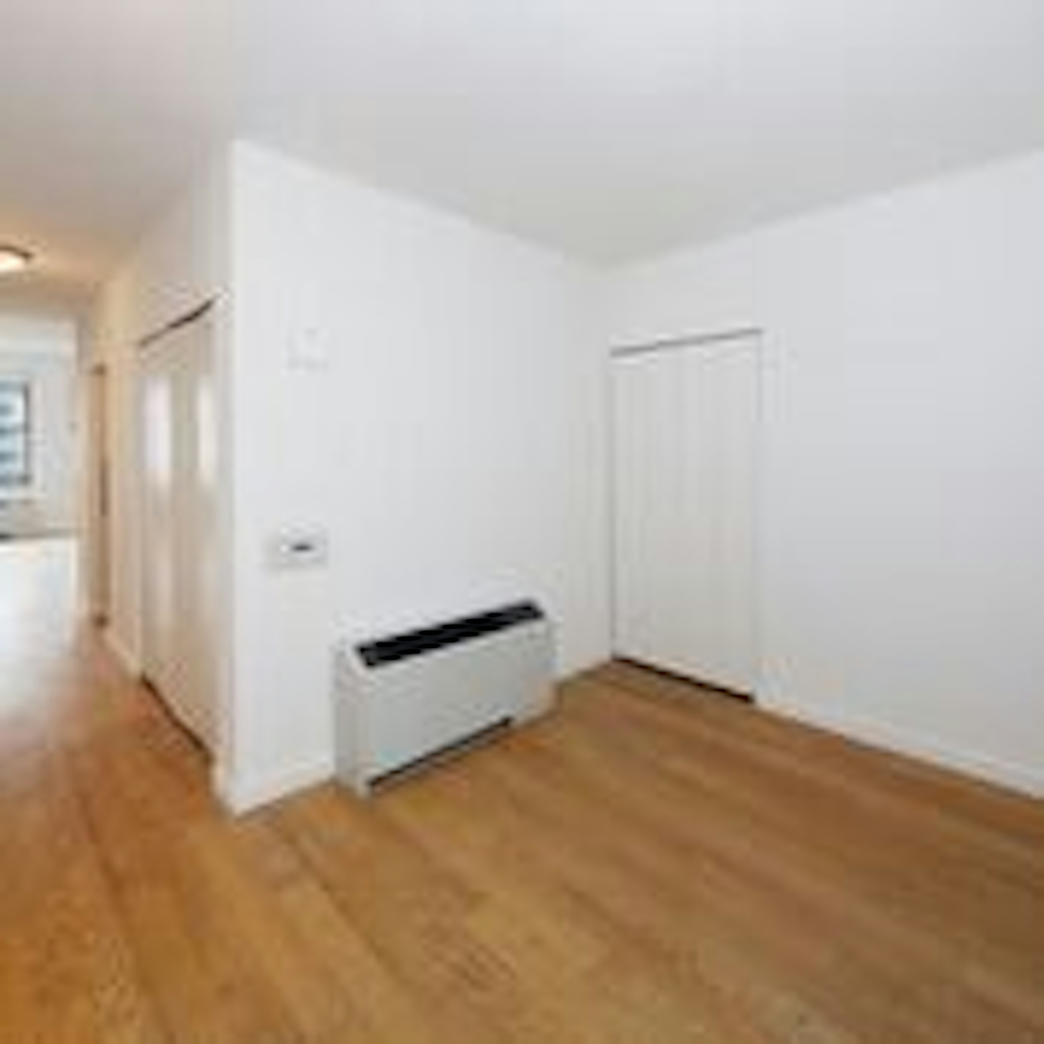 a large empty room with a hard wood floor
