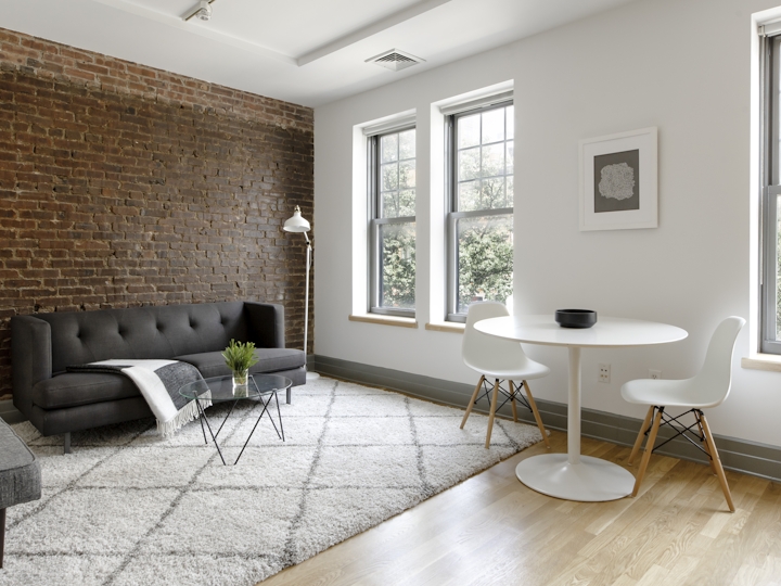 a living room filled with furniture and a large window