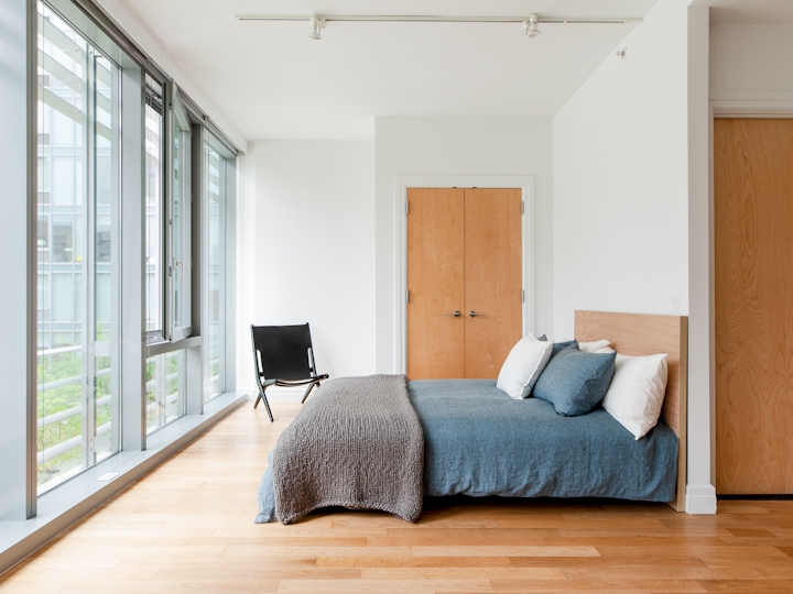 a bedroom with a wooden floor