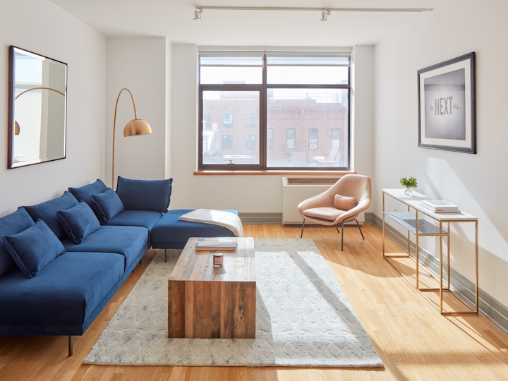 a living room filled with furniture and a large window