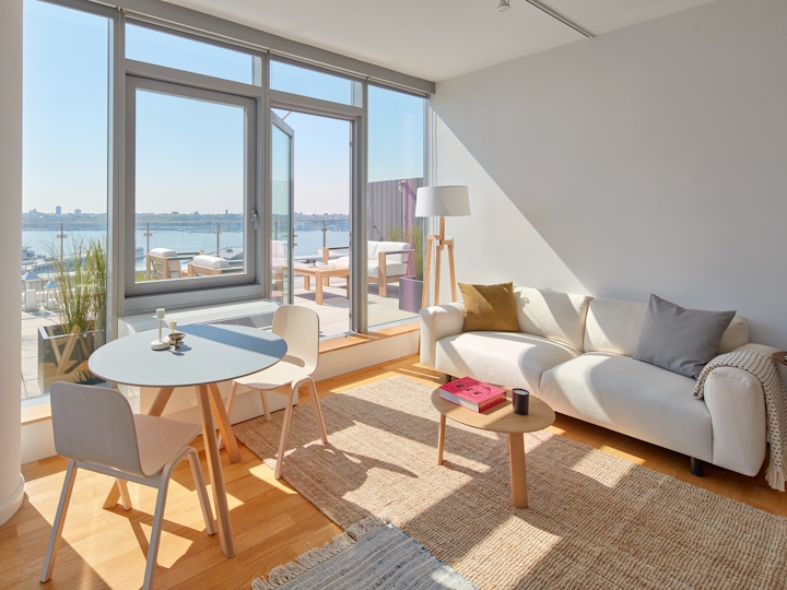 a living room filled with furniture and a large window