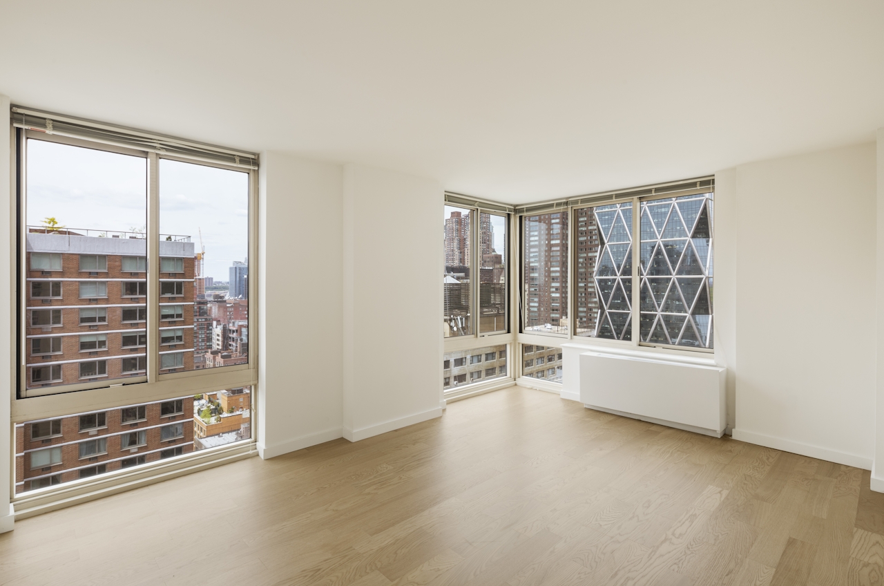 a living room filled with furniture and a large window