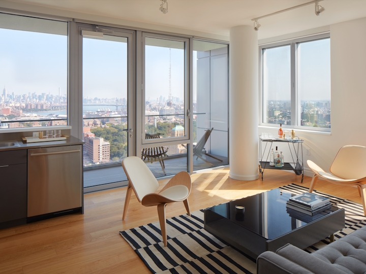 a view of a living room filled with furniture and a large window