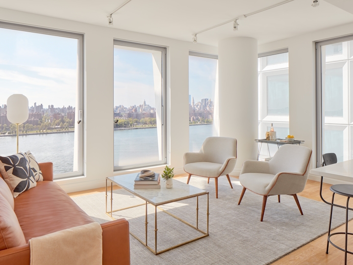 a living room filled with furniture and a large window