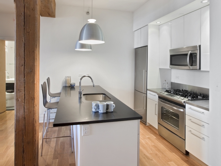 a modern kitchen with stainless steel appliances and wooden cabinets