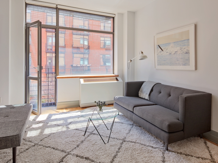 a living room filled with furniture and a large window