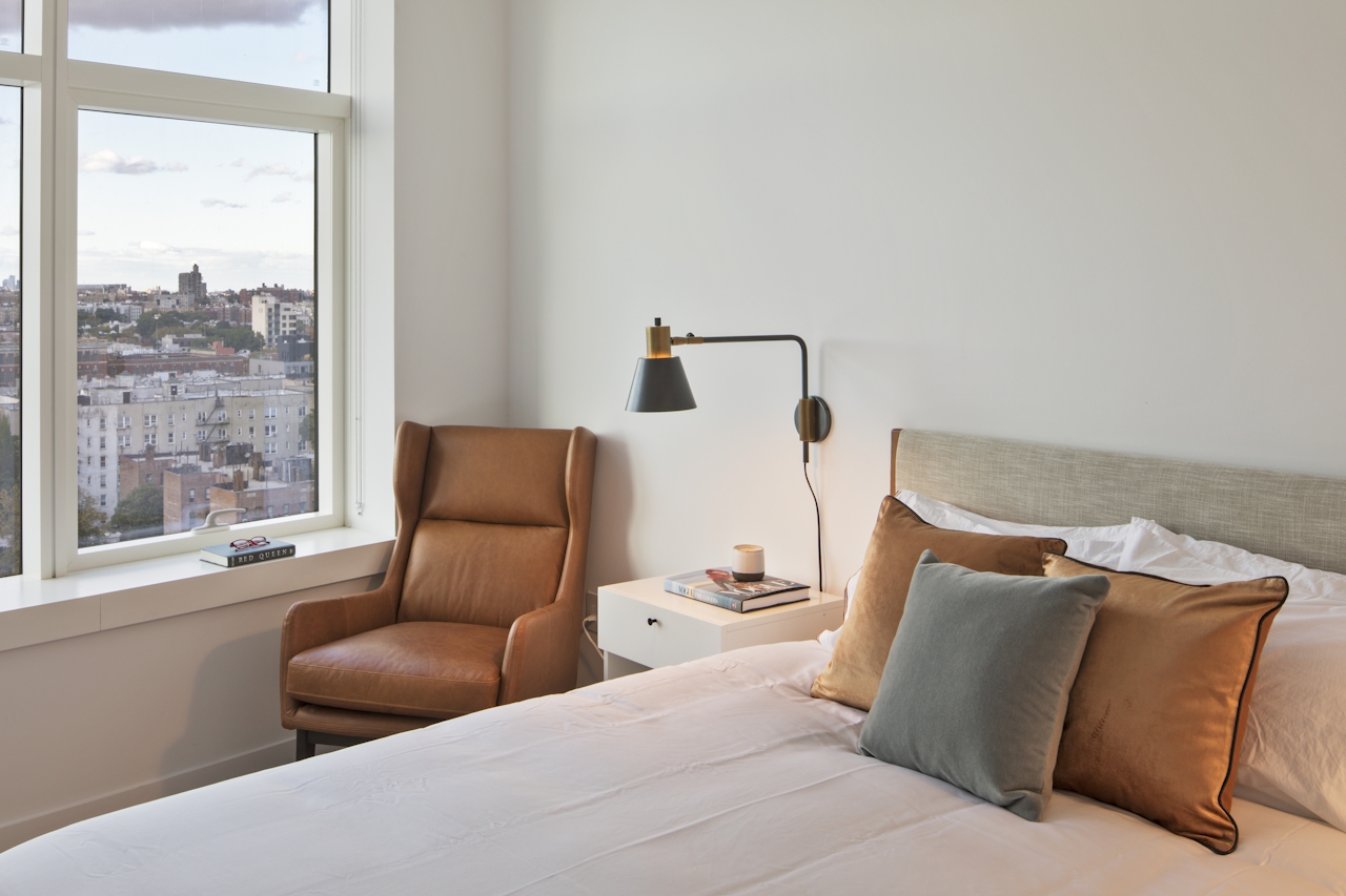 a view of a living room with a bed and a window