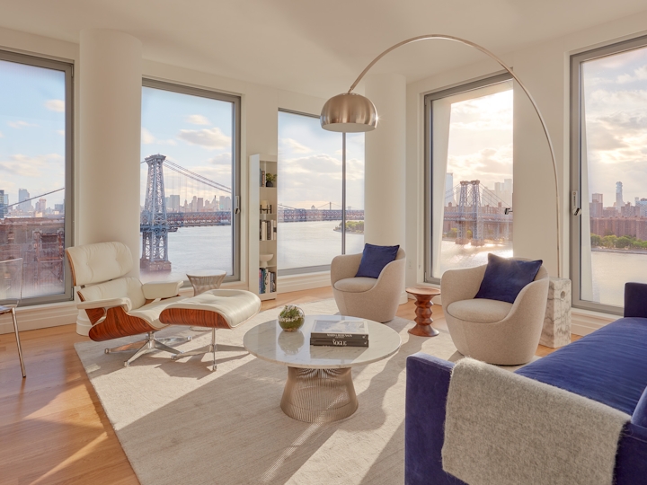 a view of a living room filled with furniture and a large window