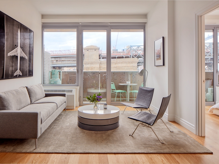 a view of a living room filled with furniture and a large window