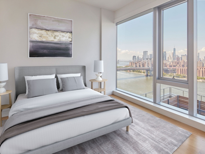 a bedroom with a bed and a large window