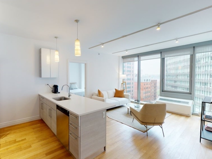 a living room filled with furniture and a large window