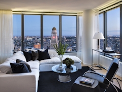 Thumbnail of The Ashland: PH2D a view of a living room filled with furniture and a large window