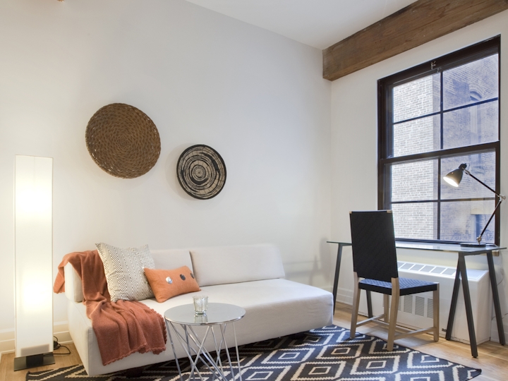 a bedroom with a bed and a chair in a room