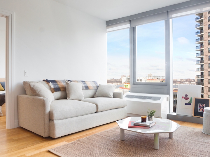 a living room filled with furniture and a large window