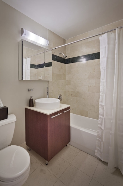 a room with a sink and a mirror