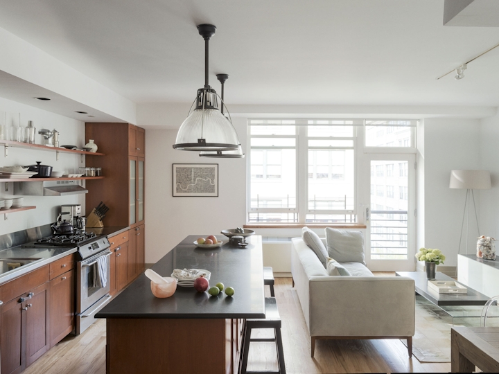 a kitchen with a sink and a dining room table