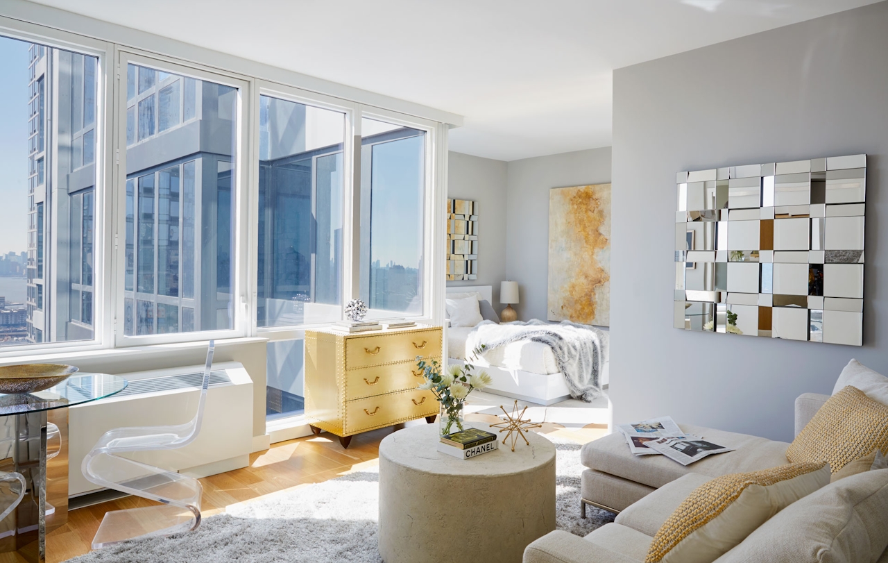 a living room filled with furniture and a large window