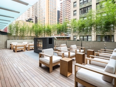 Thumbnail of Atlas New York: 22D a wooden bench sitting in front of a building