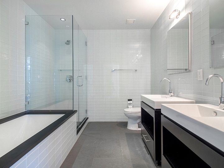 a large white tub sitting next to a glass shower door