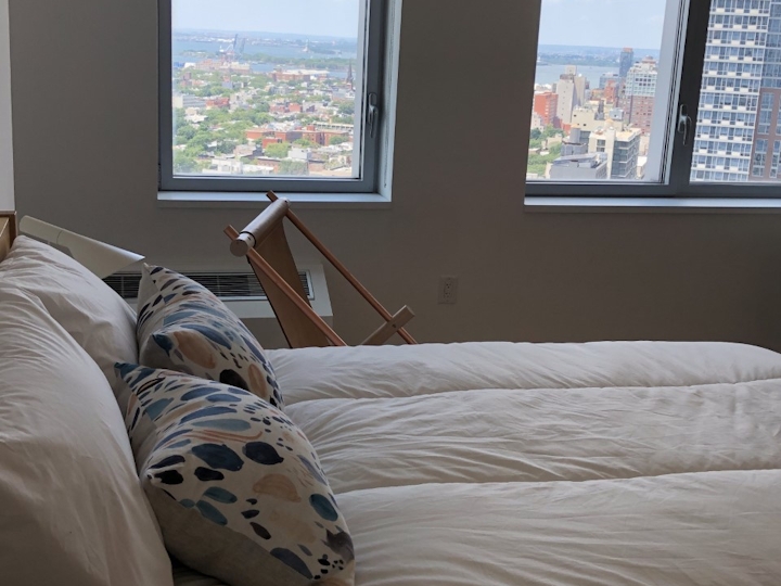 a large bed sitting next to a window