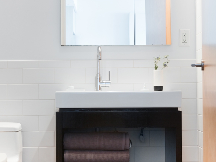 a white sink sitting under a window