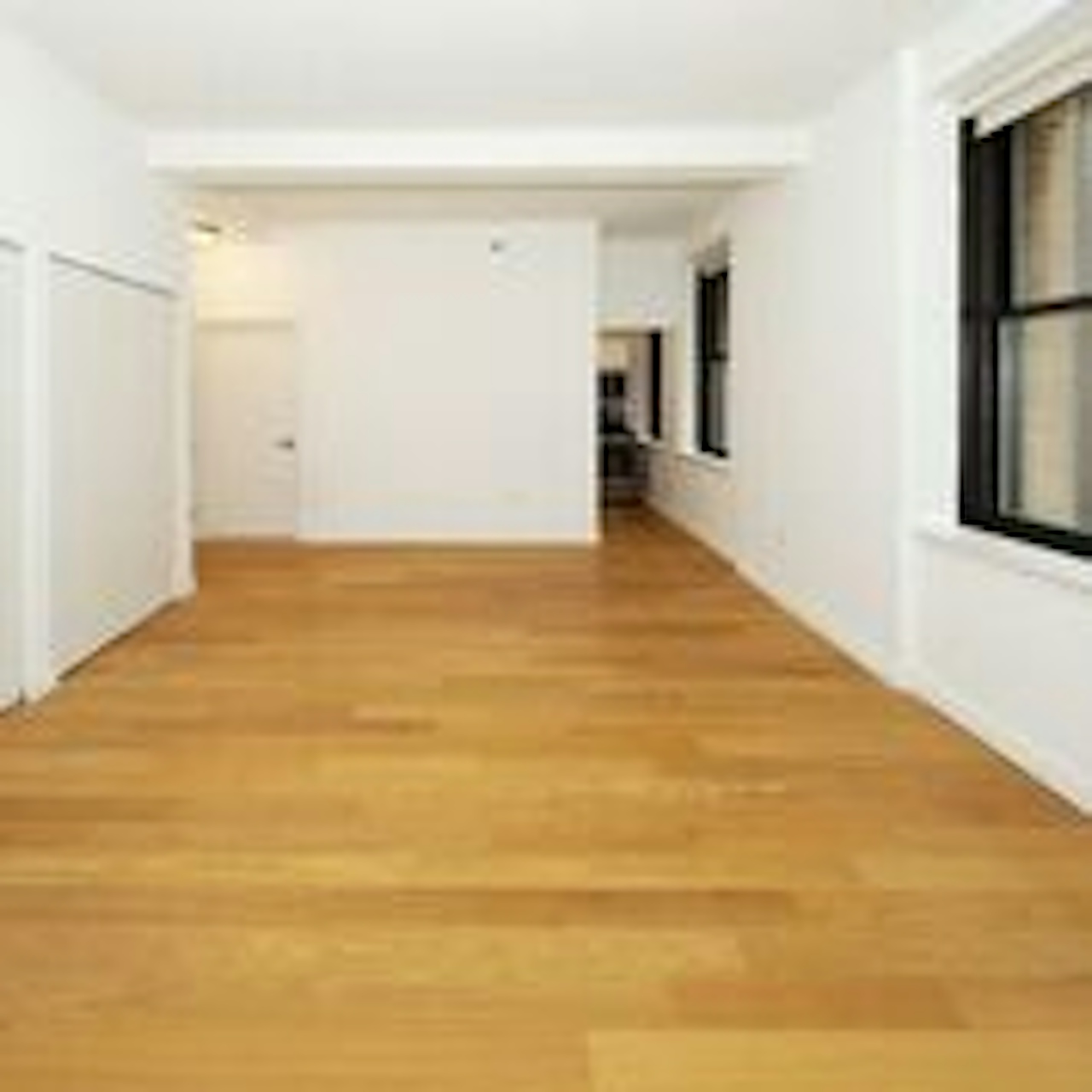 a large empty room with a wood floor